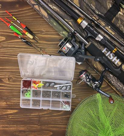 Fishing tackle. Float, wobbler, bait hooks, on a wooden background. Selective focus Fishing tackle. Float, wobbler, bait hooks, on a wooden background. Selective focus